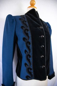 "This is a vintage YSL Rive Gauche blue and black jacket commissioned for I.Magnin stores in the 1970s or 1980s. I believe this is wool with velvet paneling. Decorated with sequin, rope and a silk like cuff that flips up revealing a velvet cuff if preferred. A high neck line collar that can be worn up or down. Button closure in the front. Mutton sleeves. Fully lined. Made in France. Labeled a French 34 although this bets fits a US 4. In excellent condition with only one loose (not broken) thread Ysl Rive Gauche, Black Velvet Jacket, Vintage Ysl, Embellished Jacket, Short Sleeve Jacket, Rive Gauche, Velvet Jacket, Pink Midi Dress, Embroidered Jacket