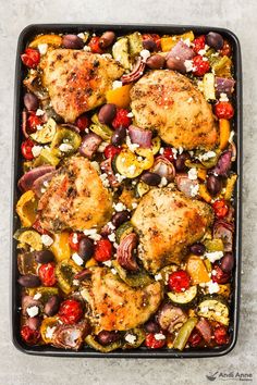 chicken and vegetables in a casserole dish with feta cheese on the side