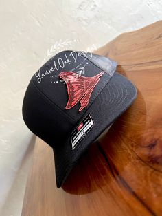 This redfish tail in red leather pops on this black and grey Richardson 112 Trucker Hat.  This hat makes a great gift for the fisherman in your life for any occasion! Black Curved Brim Fishing Hat, Adjustable Black Fishing Hat, Black Curved Brim Hat For Fishing, Adjustable Black Hat For Fishing, Black Casual Snapback Hat For Fishing, Adjustable Black Trucker Hat For Fishing, Black Flat Bill Trucker Hat For Fishing, Black Curved Bill Hat For Fishing, Black Short Brim Fishing Hat