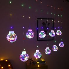 a room filled with lots of different colored lights hanging from it's ceiling next to a mirror