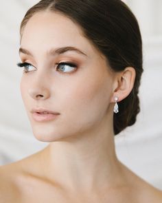 Glamour & elegance meet with our Tilly Dangle Earrings. Designed with a shimmering teardrop crystal, these earrings are perfect for the minimalist bride or bridesmaids. Cubic Zirconia Measures 1" in length Hypoallergenic, lead-free & nickel-free Style #4441 Glamorous Teardrop Diamond Earrings For Wedding, Classic Teardrop Linear Earrings For Wedding, Elegant Teardrop Crystal Bridal Earrings, Teardrop Cubic Zirconia Bridal Earrings, Classic Pear-shaped Chandelier Earrings, Classic Teardrop Crystal Earrings, Classic Crystal Teardrop Bridal Earrings, Elegant Teardrop Crystal Earrings, Formal Crystal Teardrop Earrings With Pearl Drop