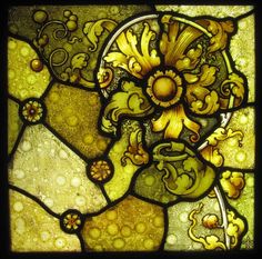 a stained glass window with yellow and green designs