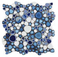 a blue and white mosaic tile with small circles on the bottom, surrounded by smaller dots