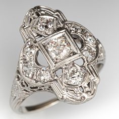 an antique style diamond ring with filigrees