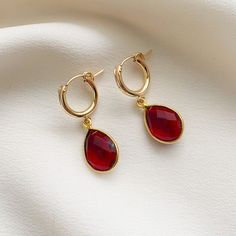 Beautiful garnet pear shape bezel-set gemstones dangle from 14k gold fill click style hoop earrings.  Garnet is the birthstone for January and symbolizes inner force, passion, and love.  These simple earrings make a lovely gift for loved ones born in January or for fans of this beautiful hue. If you are looking for this style in other colors, they are available in gemstones for all the months of the year in my shop.   ✤Hoops: 13mm diameter ✤Gemstone Charms: 18.5x11.5mm Stone diameter: 14 x 10mm Classic Teardrop Earrings With Bezel Setting, Classic Teardrop Bezel Set Earrings, Fine Jewelry Teardrop Pendant Earrings As Gift, Fine Jewelry Teardrop Earrings For Gift, Elegant Teardrop Hoop Earrings With Birthstone, Elegant Teardrop Birthstone Hoop Earrings, Round Gemstone Teardrop Earrings For Anniversary, Round Teardrop Gemstone Earrings For Anniversary, Gold Teardrop Hoop Earrings With Birthstone