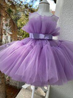 The listing color is Purple! If your little one is a true Purple lover, this dress is totally a dream design for her! It comes with a FREE matching headpiece that is totally adorable. The soft and finest Purple tulle meets with a ribbon waist belt on the center, giving the cutest cupcake look to your little one! Skirt has so many tulle layers that makes it a very puffy and fluffy look. An invisible zipper added to the back for the comfort of your little girl. Can be made in almost any color. See Lavender Tulle Tutu Dress For Party, Elegant Tutu Dress With Tulle Skirt For Birthday, Lavender Ruffled Princess Dress For Birthday, Cute Purple Tutu Dress For Birthday, Purple Cute Tutu Dress For Birthday, Lavender Ruffle Dress For Birthday, Lavender Ruffled Dress For Birthday, Cute Fitted Dress As A Gift, Purple Princess Tutu Dress For First Birthday