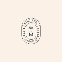 the wm logo is shown in black and white on a beige background, with an oval