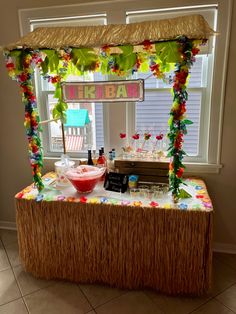 a tiki bar is set up in the middle of a room with lots of decorations