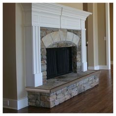 an empty fireplace in the middle of a living room