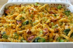 a casserole dish with broccoli, ham and noodles in it on a table