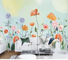 a room with flowers painted on the wall and a table in front of it next to a window