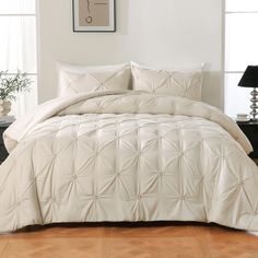 a white comforter set in a bedroom