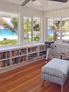 a living room filled with furniture and lots of windows