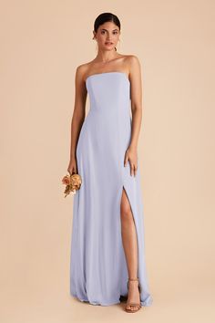 a bridesmaid in a strapless blue dress with a slit down the side