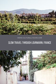 an alley way with trees and bushes on either side, and the words slow travel through lourmainn france