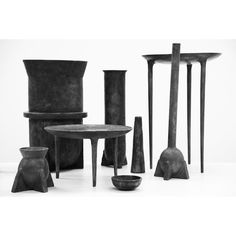 an assortment of black and white vases, tables and chairs in various shapes and sizes