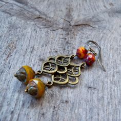 This series has a lot of beautiful orange, yellow, and red Czech glass beads. There are several items in the series that will all mix and match. Be sure to click on the link below. This listing is for these long dangle earrings with beautiful yellow orange beads. The bottom bead is 12 x 10mm with a Picasso finish. The top bead is a mix of glass and each bead is slightly different. Every bead is unique and beautiful. These are offered with antique brass findings and your choice of brass or titani Multicoloured Earrings, Autumn Earrings, Autumn Jewelry, Earrings Fall, Fall Earrings, Lake Forest, Long Dangle Earrings, Fall Jewelry, Pretty Earrings