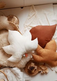 pillows and other decorative items lay on a bed