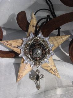 a star shaped brooch sitting on top of a white cloth