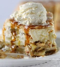 a close up of a piece of cake on a plate with ice cream and caramel