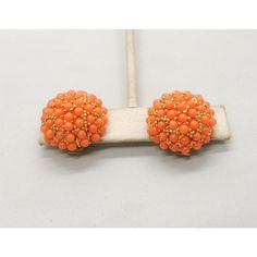 This is part of Chairish’s Costume Jewelry assortment.  1960s round goldtone pave cabochon pale orange faux-coral studded domed clip earrings. Marked "Hobe." Measure: 7/8 inches across by 1/2 inch deep. Condition: Very good; some yellowing to plastic rollers on the backs normal for their age. Orange Clip-on Earrings For Formal Occasions, Formal Orange Clip-on Earrings, Elegant Orange Clip-on Earrings, Vintage Orange Beaded Earrings, Orange Beaded Vintage Earrings, Vintage Orange Clip-on Earrings, Vintage Orange Earrings For Party, Orange Vintage Earrings For Party, Vintage Orange Round Earrings