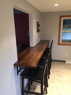 a long wooden table sitting in the middle of a room