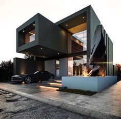 two cars are parked in front of a modern house