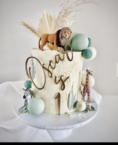 a birthday cake decorated with animals and letters