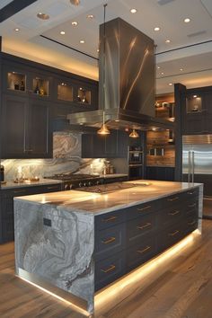 a large kitchen with marble counter tops and stainless steel appliances, along with wooden flooring