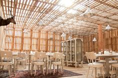 an empty restaurant with wooden walls and tables