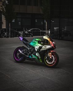 a colorful motorcycle parked in an empty parking lot