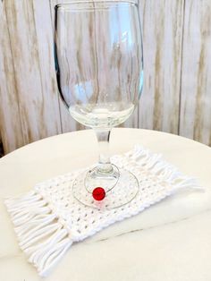 a wine glass sitting on top of a white table