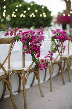 the chairs are lined up with flowers on them