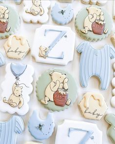 baby shower cookies are arranged in the shape of numbers and animals, including one bear