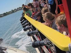 children are riding on a boat in the water