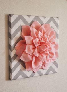 a pink flower on a gray and white chevroned canvas with grey and white stripes