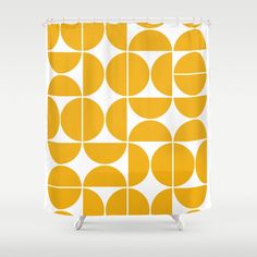 an orange and white shower curtain with circles in the center, on a gray background