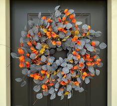 an orange and grey wreath on the front door