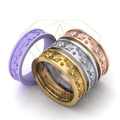 three different colored wedding rings with flowers on the sides and one is gold, silver, and purple