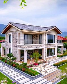 an aerial view of a house with flowers in the front yard