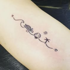 a woman's arm with the word love on it and an image of a sea shell