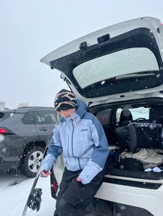 a person sitting in the back of a car on skis