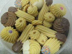 a plastic bowl filled with cupcakes covered in frosting