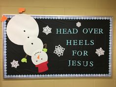 a bulletin board with two snowmen on it that says head over heels for jesus