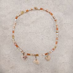 Anna Maria Pearl & Shell Necklace – Essenshell Bohemian Pearl Charm Necklaces For Beach, Bohemian Shell-shaped Charm Necklaces, Beach Pearl Charm Necklaces With Shell, Beach Charm Necklaces With Pearl And Shell, Beach Shell Charm Necklaces With Pearl, Handmade Bohemian Shell Charm Necklace, Orange Spiritual Jewelry For Beach, Beach Jewelry With Gemstone Shell Beads, Bohemian Pearl Charm Necklace For Vacation