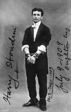 an old black and white photo of a man in a suit with his hands on his hips