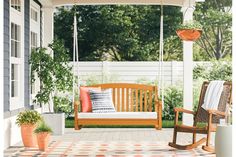 a wooden porch swing sitting on top of a tiled floor