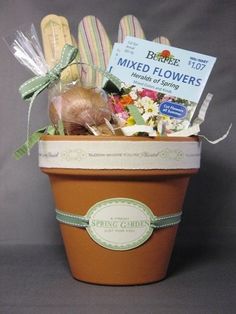 a flower pot filled with fake flowers and gardening utensils