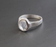 ♦♦ Beautiful handcrafted ring ◘Stone Information: Genuine Crystal Quartz - Cut: Rose Cut Size: 11x15 mm ◘ Metal: 925 Sterling Silver ◘ Band: 2 mm textured ◘ Setting: Open back bezel setting ◘ Finish: High polish (shiny) ◘ Nickel free ◘ Anti tarnish ◘ Vermeil Gold ◘ Handmade band: 14 gauge solid sterling wire This ring is adorably rustic, easy to wear, & stackable! ◘Please Note - The Ring in the Picture can be available or Sold out. Every Ring is Made of a Unique Gemstone. Therefore, Colors a Clear Quartz Ring, Bridesmaid Ring, Bridesmaid Rings, Ring Proposal, Zierlicher Ring, Natural Gemstone Ring, Textured Ring, Jewelry Crystal, Ring Stacking