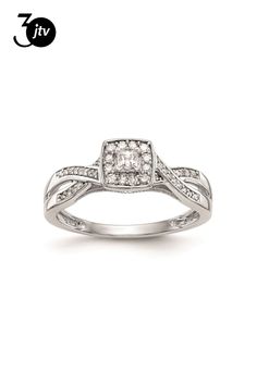 a white gold ring with diamonds on the sides and a diamond set in the middle